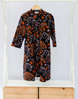 Black dress with orange and white small leaves