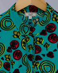 display of a green, red and yellow vegetable design dress
