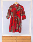 Display of red shaded, large feather print dress.