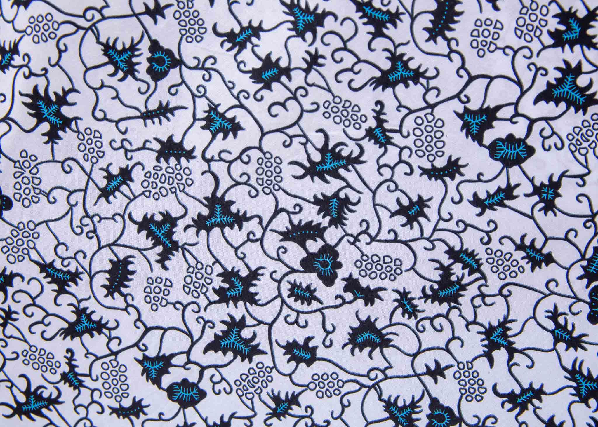 Display of white sleeveless dress with blue floral print.