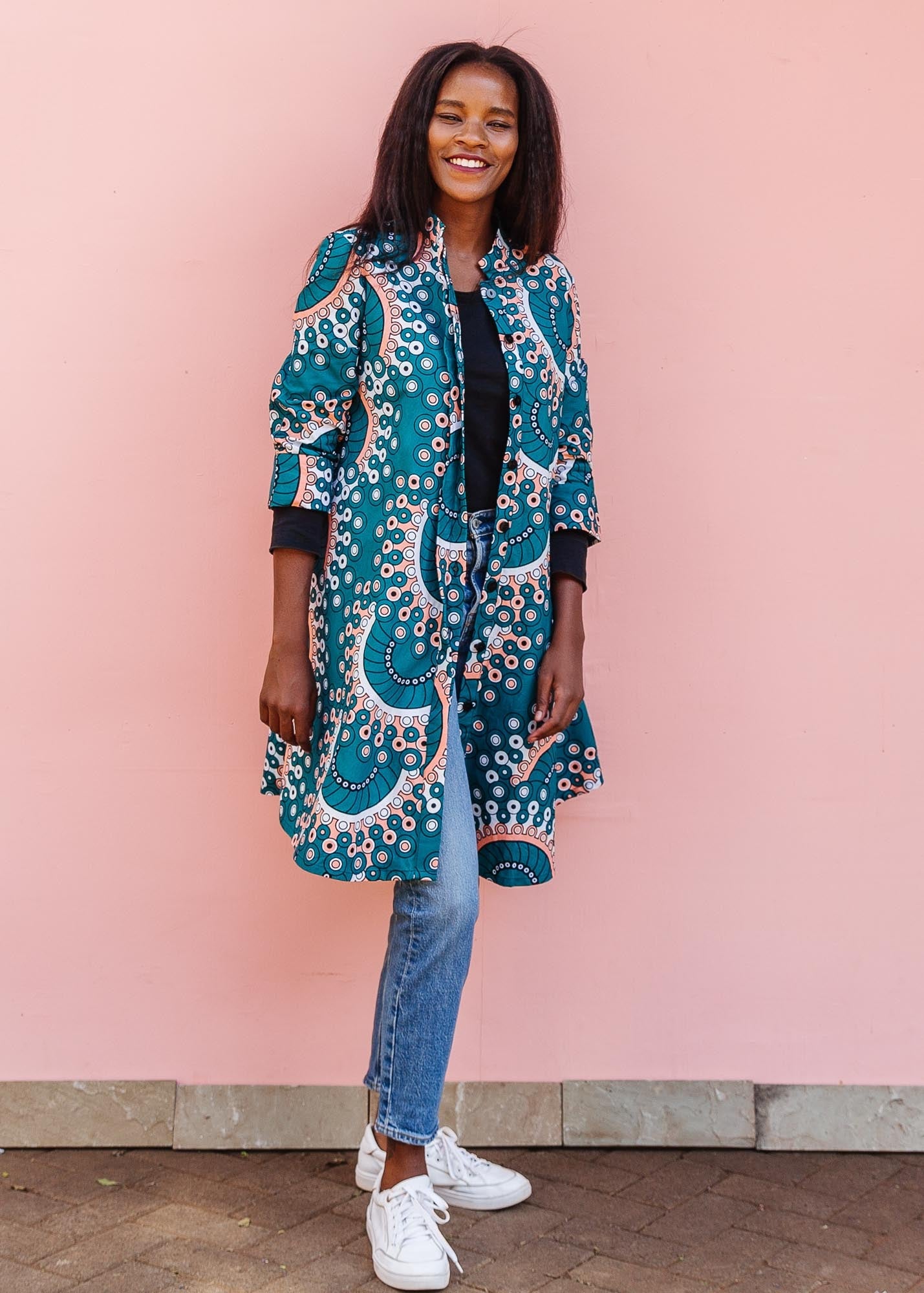 The model is wearing teal, white, black and peach dress with gears