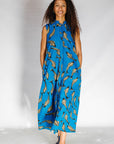 Model wearing blue dress with beige fish print.
