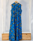 Display of blue dress with beige fish print.