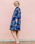 Model wearing blue floral print dress