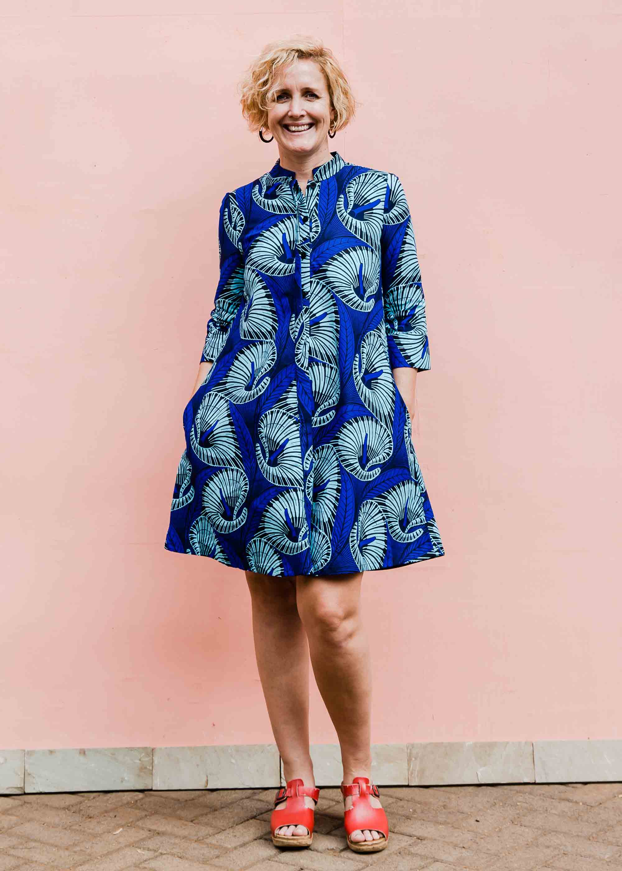 model wearing a blue lily design dress