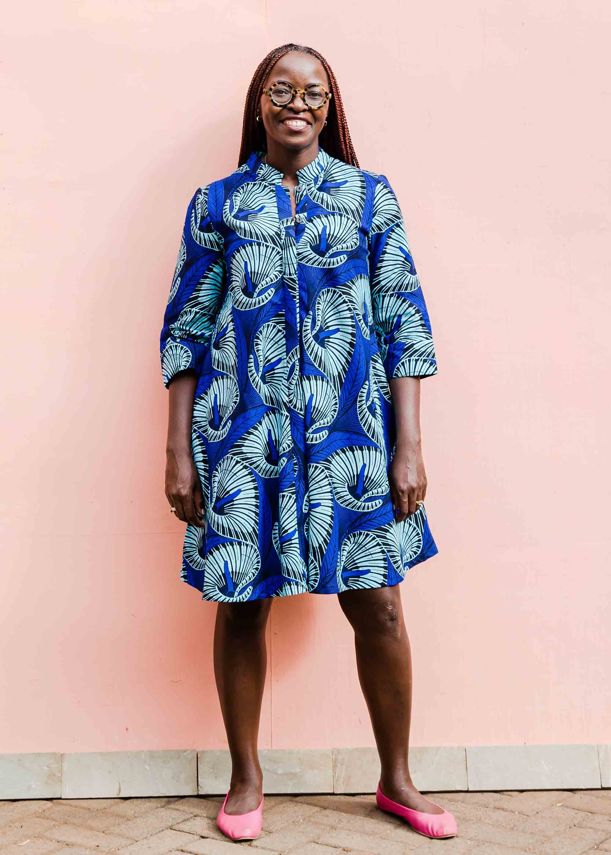 model wearing a blue lily design dress