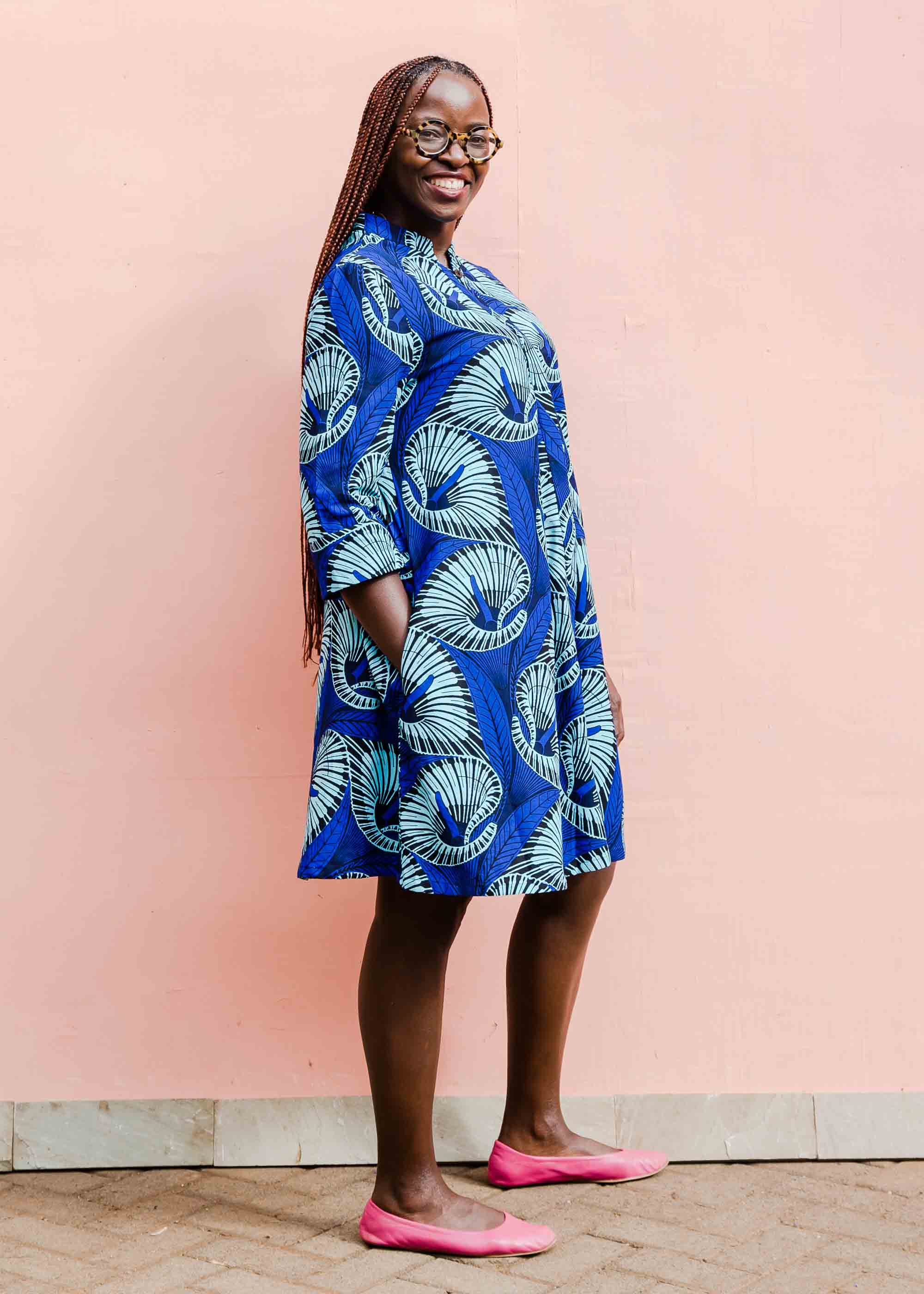 model wearing a blue lily design dress