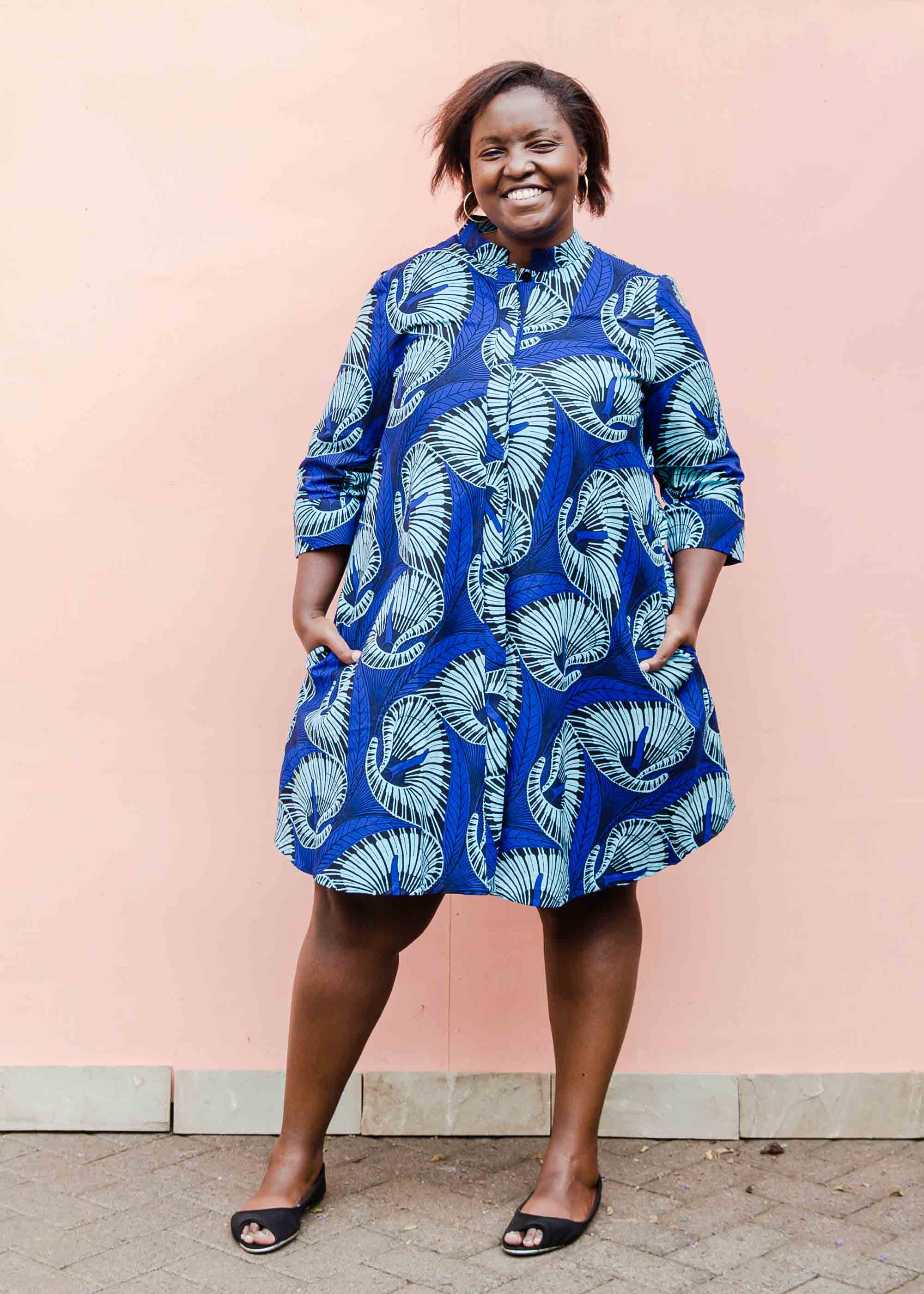 model wearing a blue lily design dress