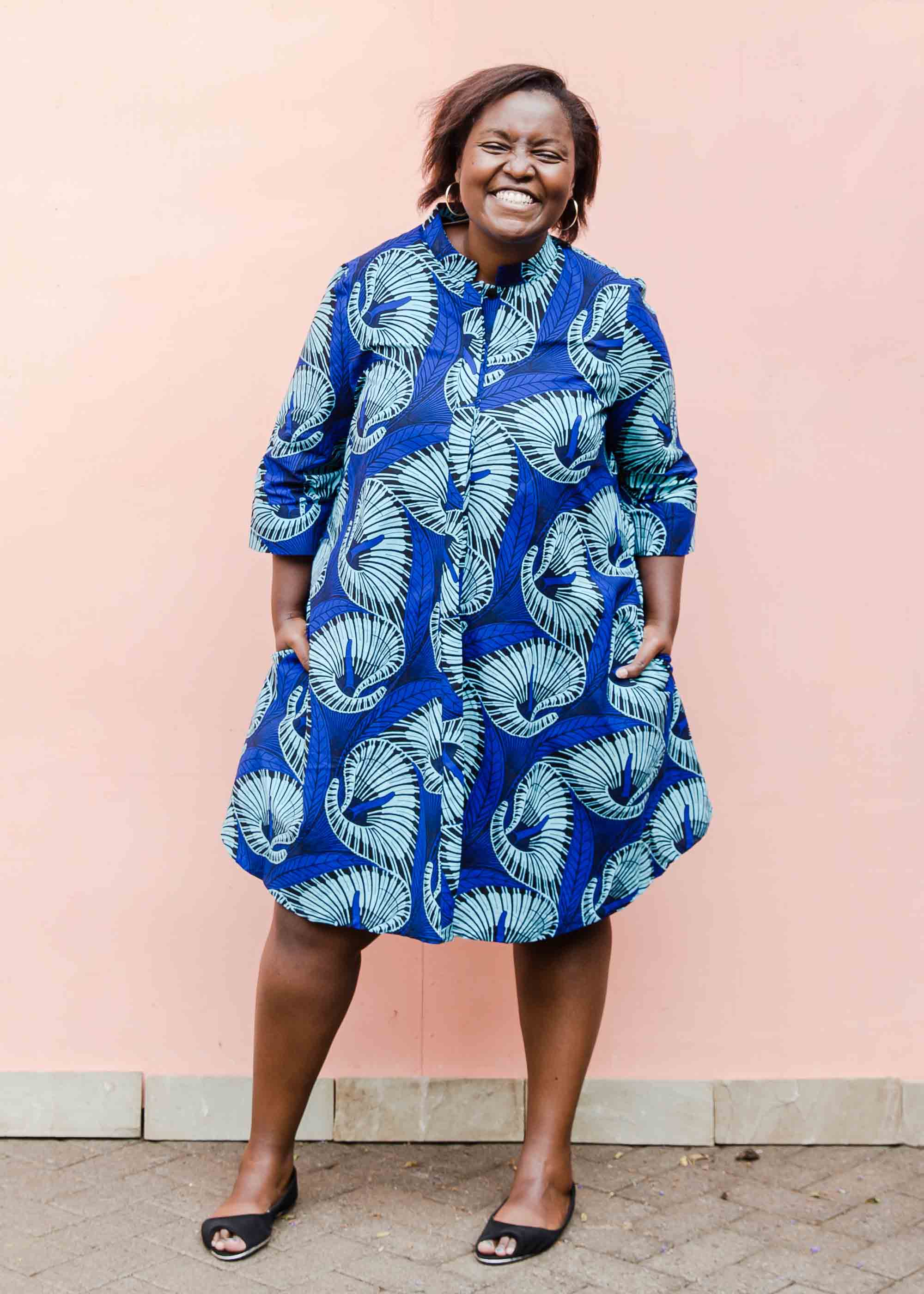 model wearing a blue lily design dress