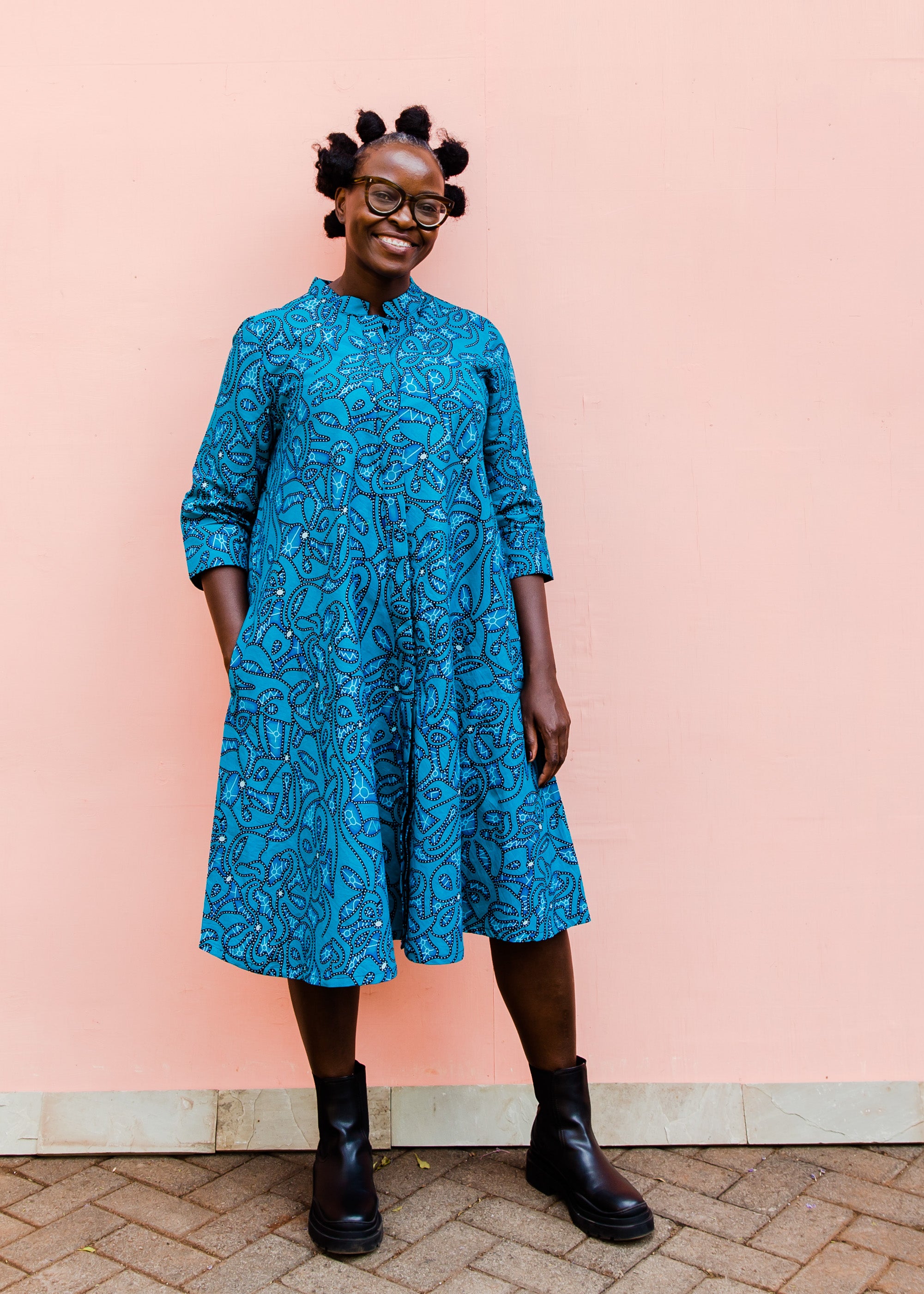 Model wearing blue squiggle print dress.