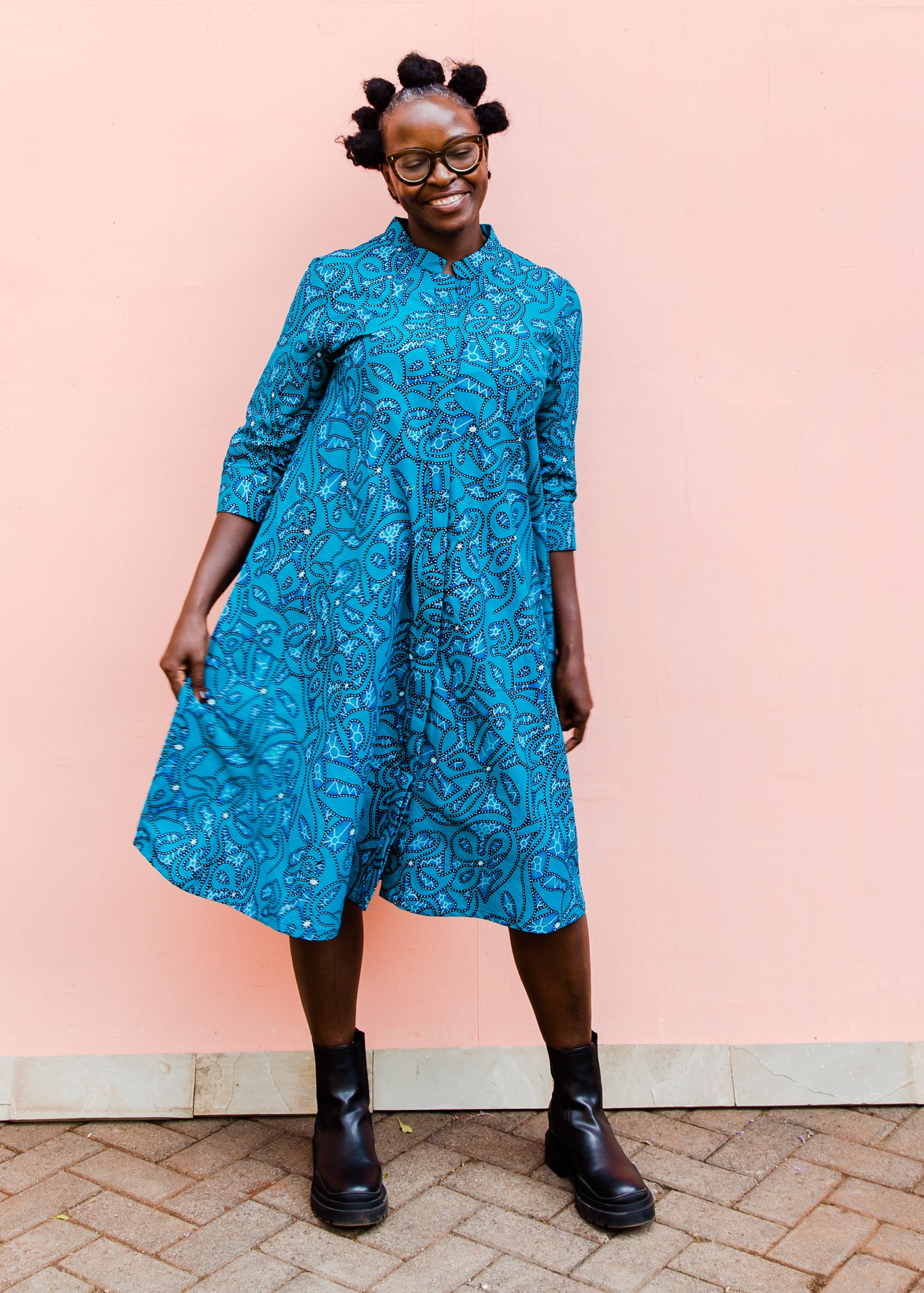 Model wearing blue squiggle print dress.