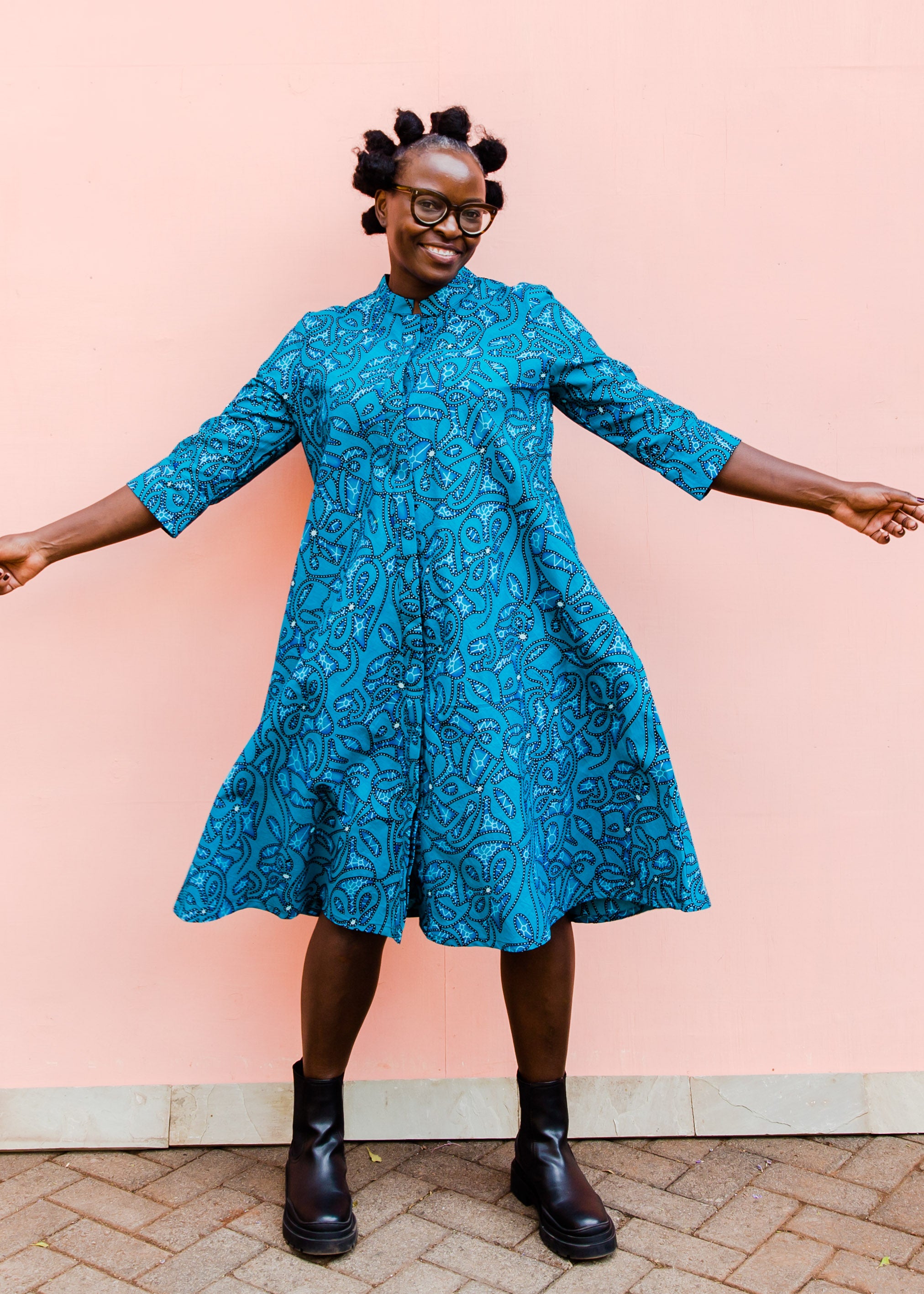 Model wearing blue squiggle print dress.