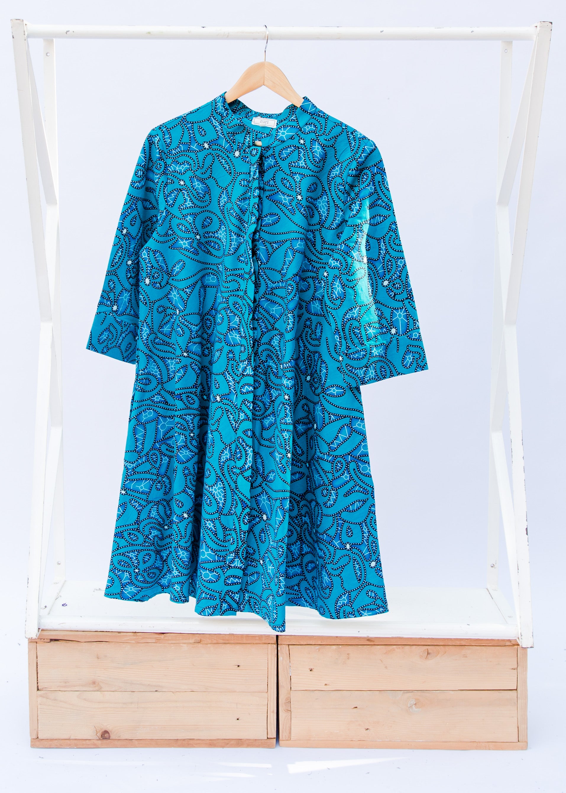 Display of blue squiggle print dress.