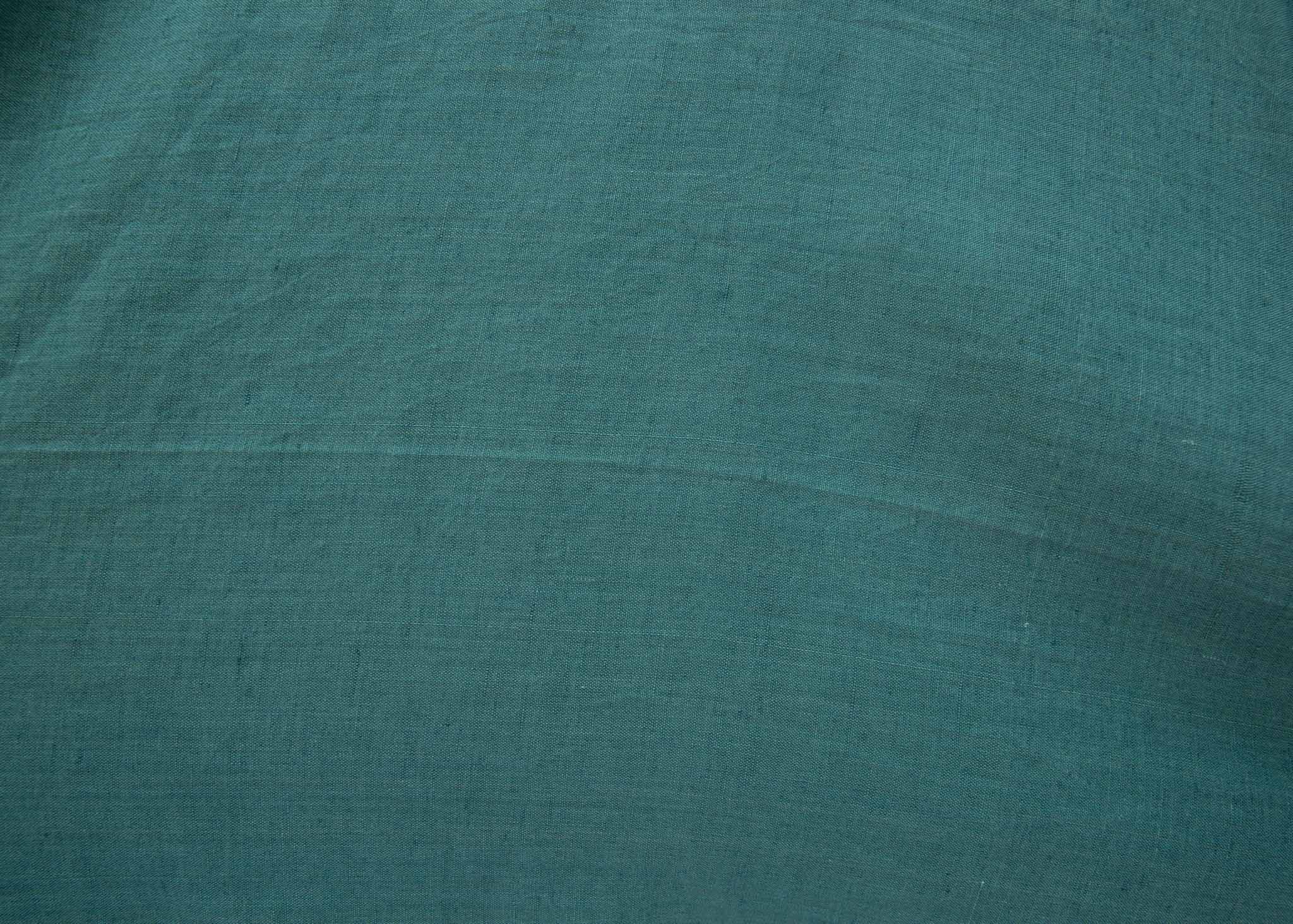 Close up of lagoon green linen fabric.
