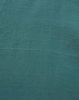 Close up of lagoon green linen fabric.