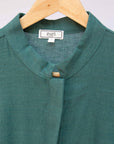 Close up display of lagoon green linen dress.