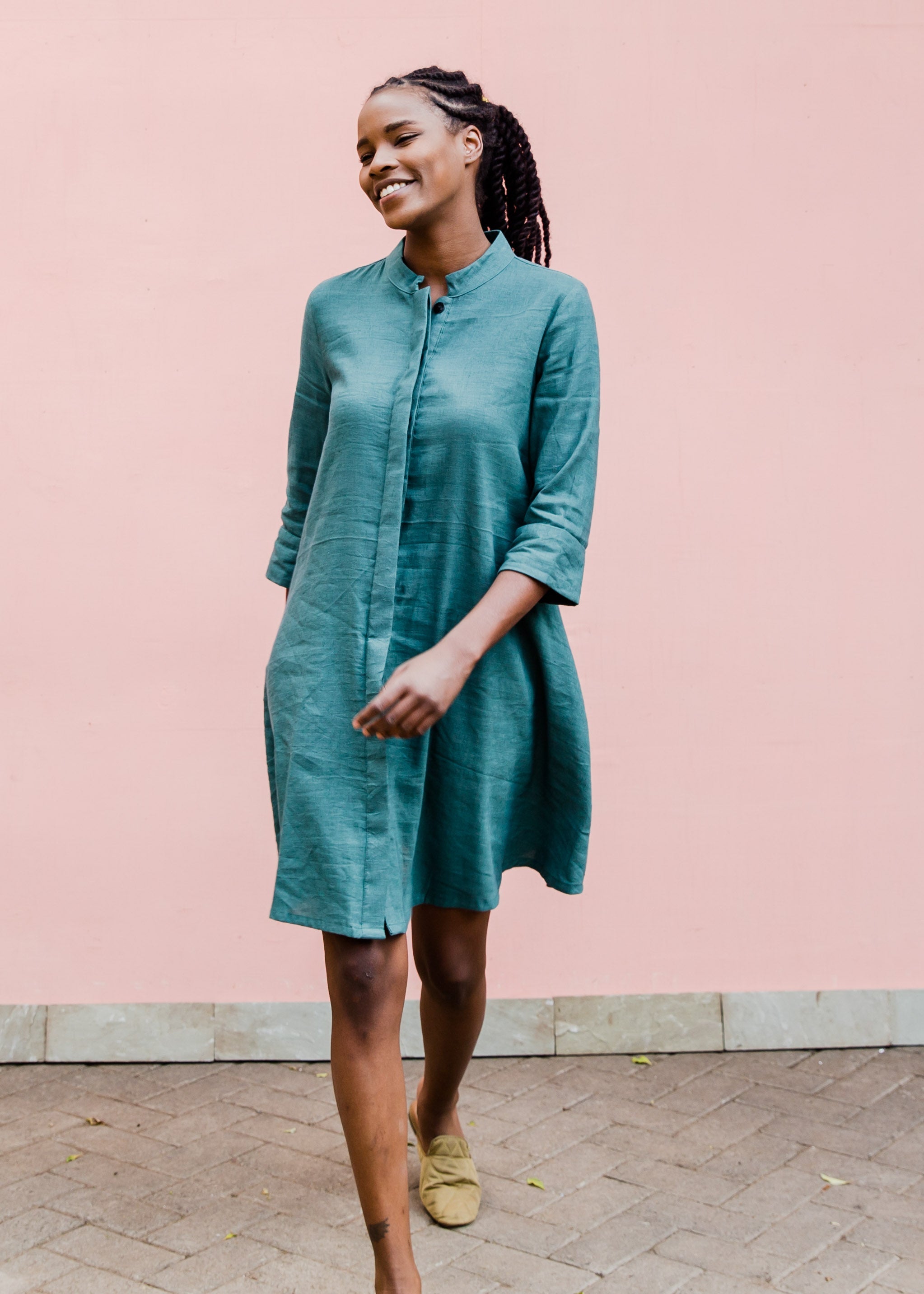 Model wearing lagoon green linen dress.