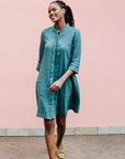 Model wearing lagoon green linen dress.