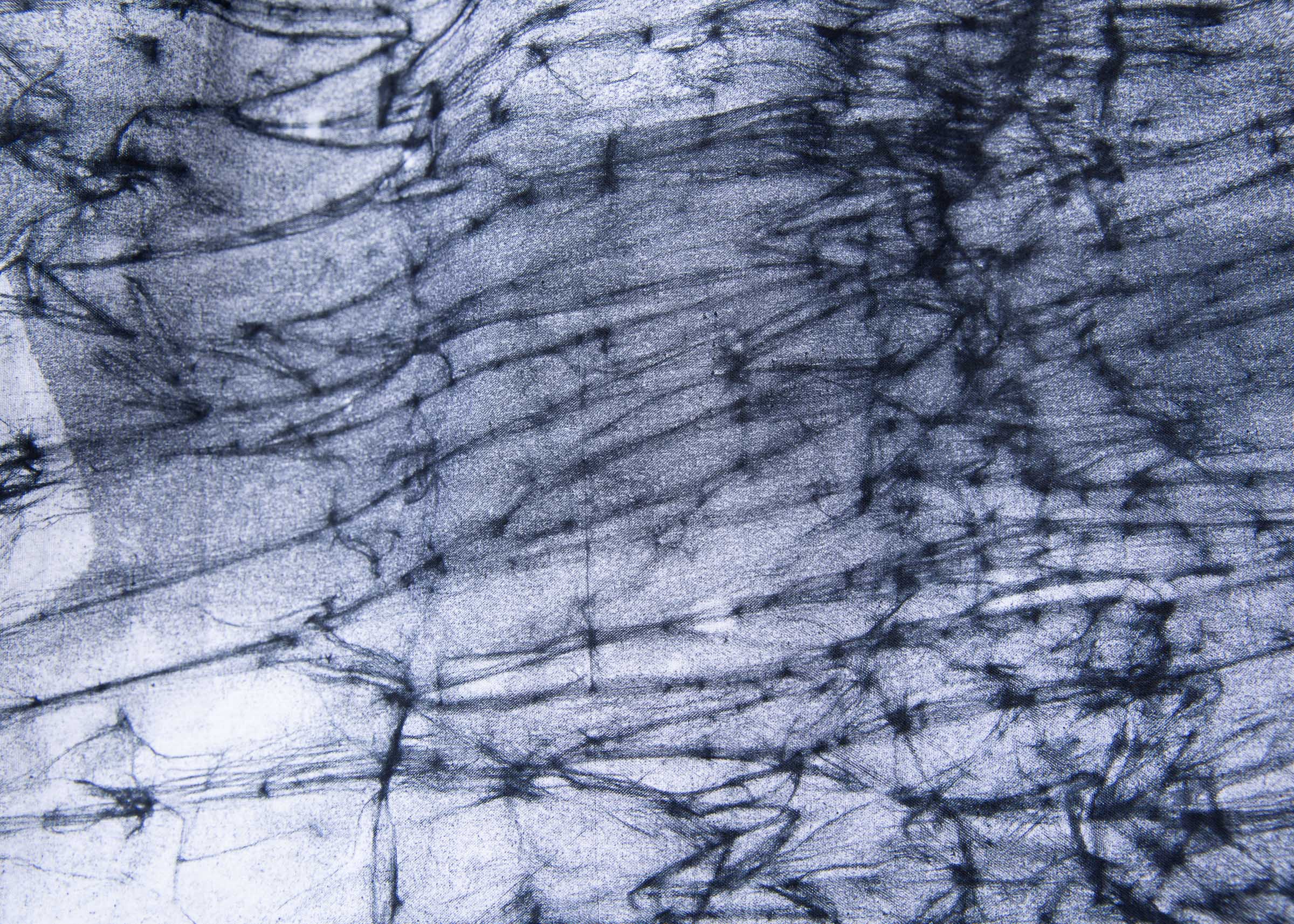 Close up display of black and white long sleeve batik blouse.