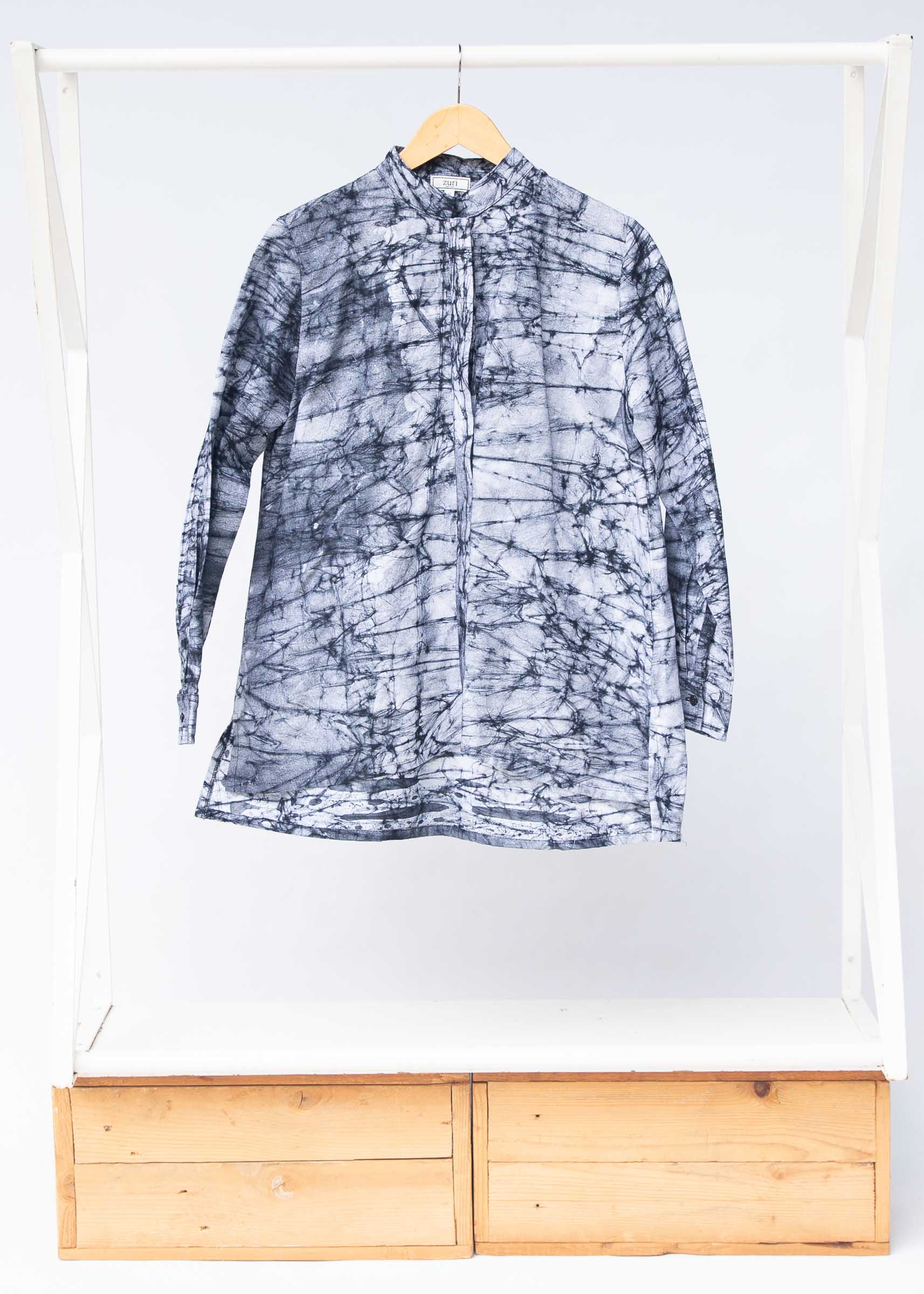 Display of black and white long sleeve batik blouse.