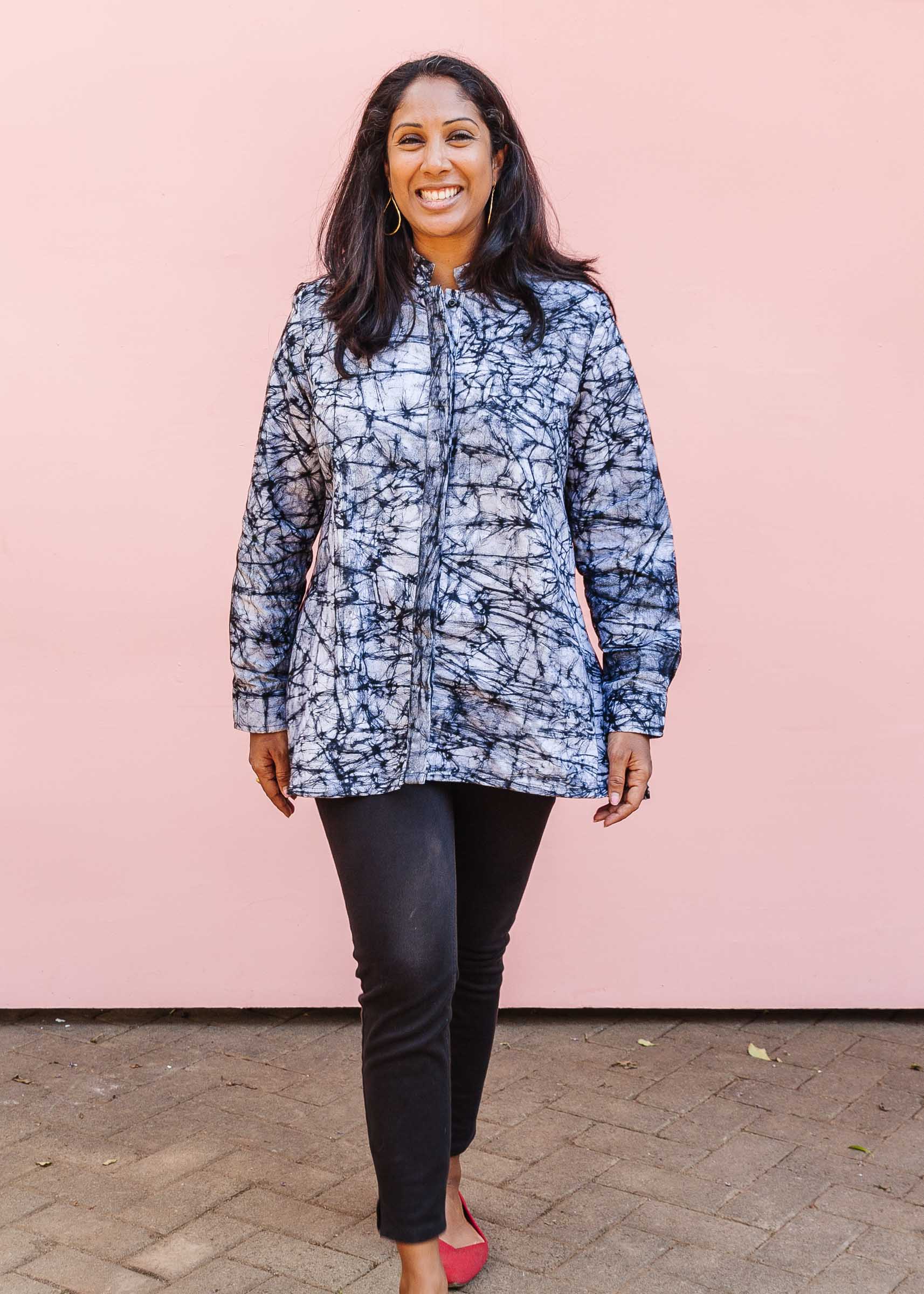 Model wearing black and white long sleeve batik blouse.