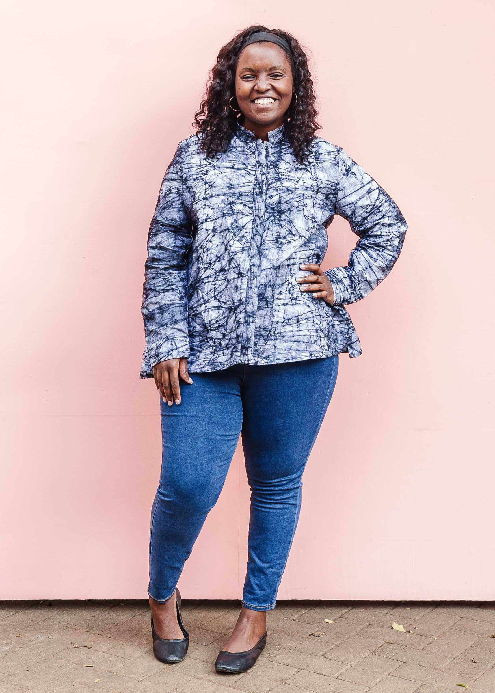 Model wearing black and white long sleeve batik blouse.