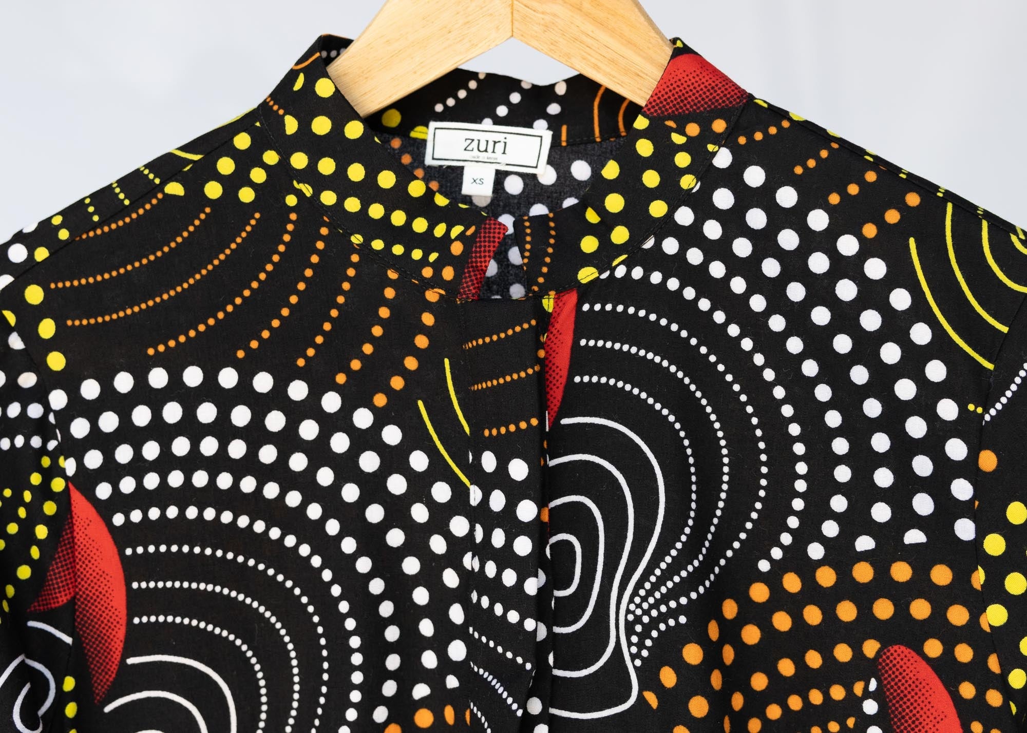 detail of abstract geometric midi-length belted dress
