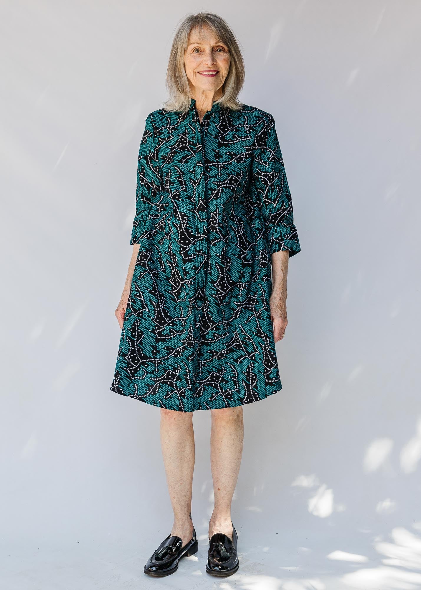 model wearing teal printed dress