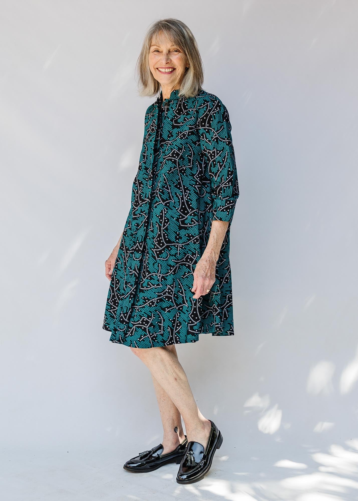 model wearing teal printed dress