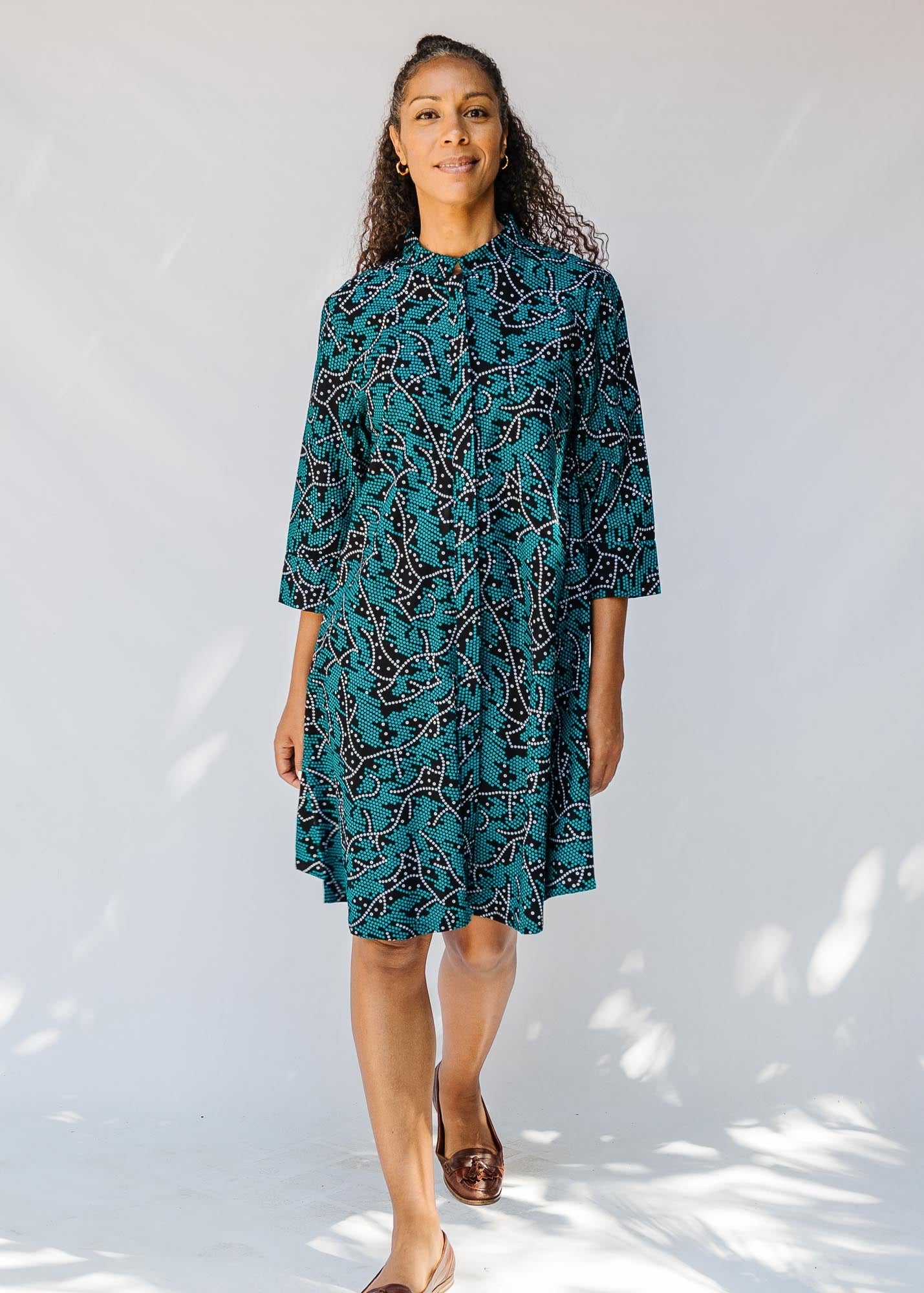 model wearing teal printed dress