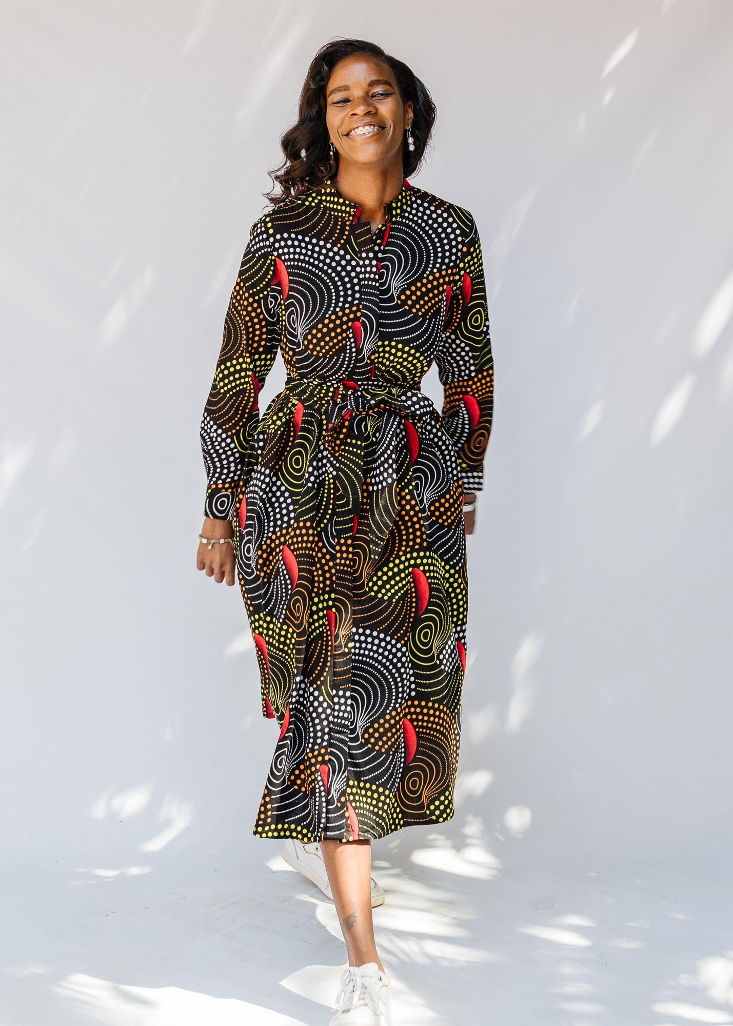 model wearing abstract geometric midi-length belted dress