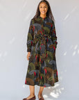 model wearing abstract geometric midi-length belted dress