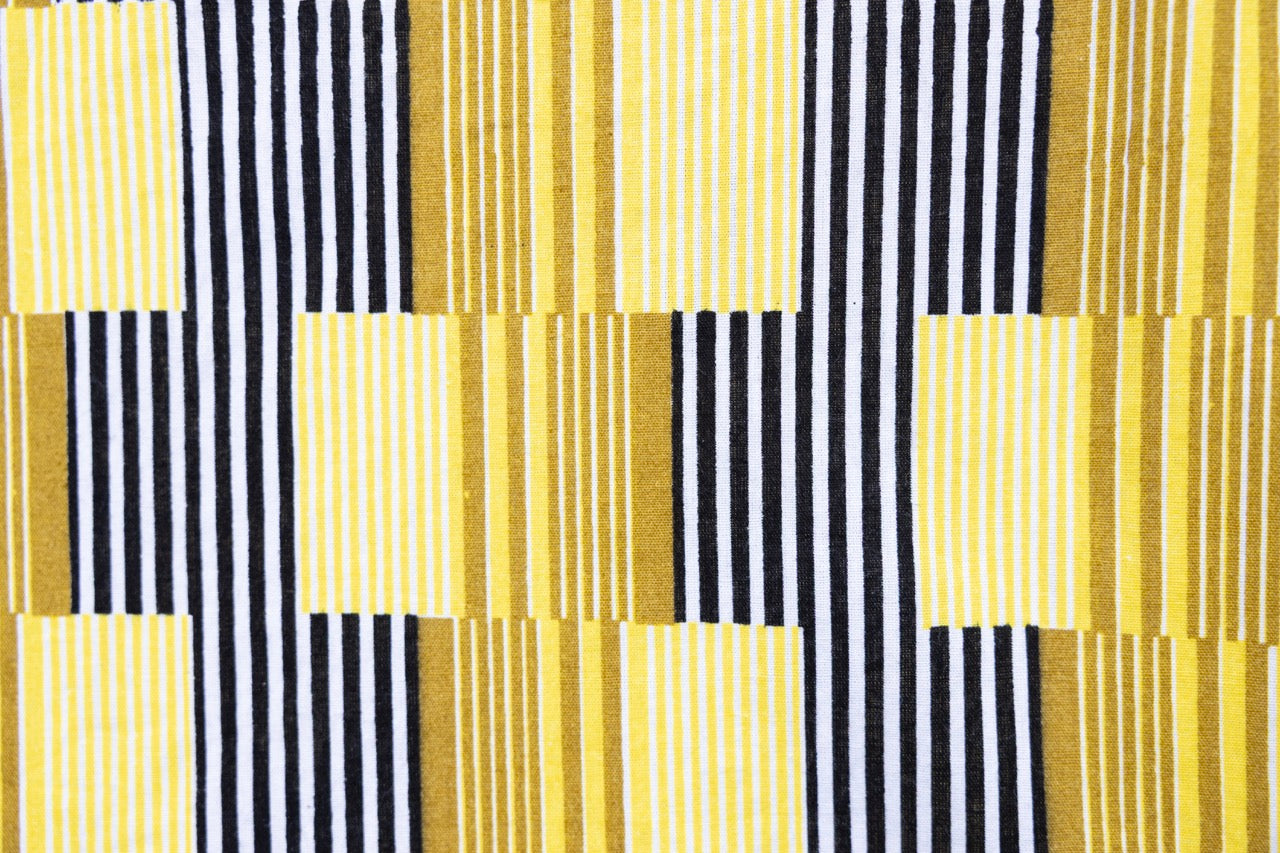 Close up display of yellow and black striped dress.