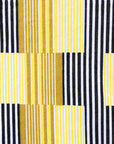 Close up display of yellow and black striped dress.