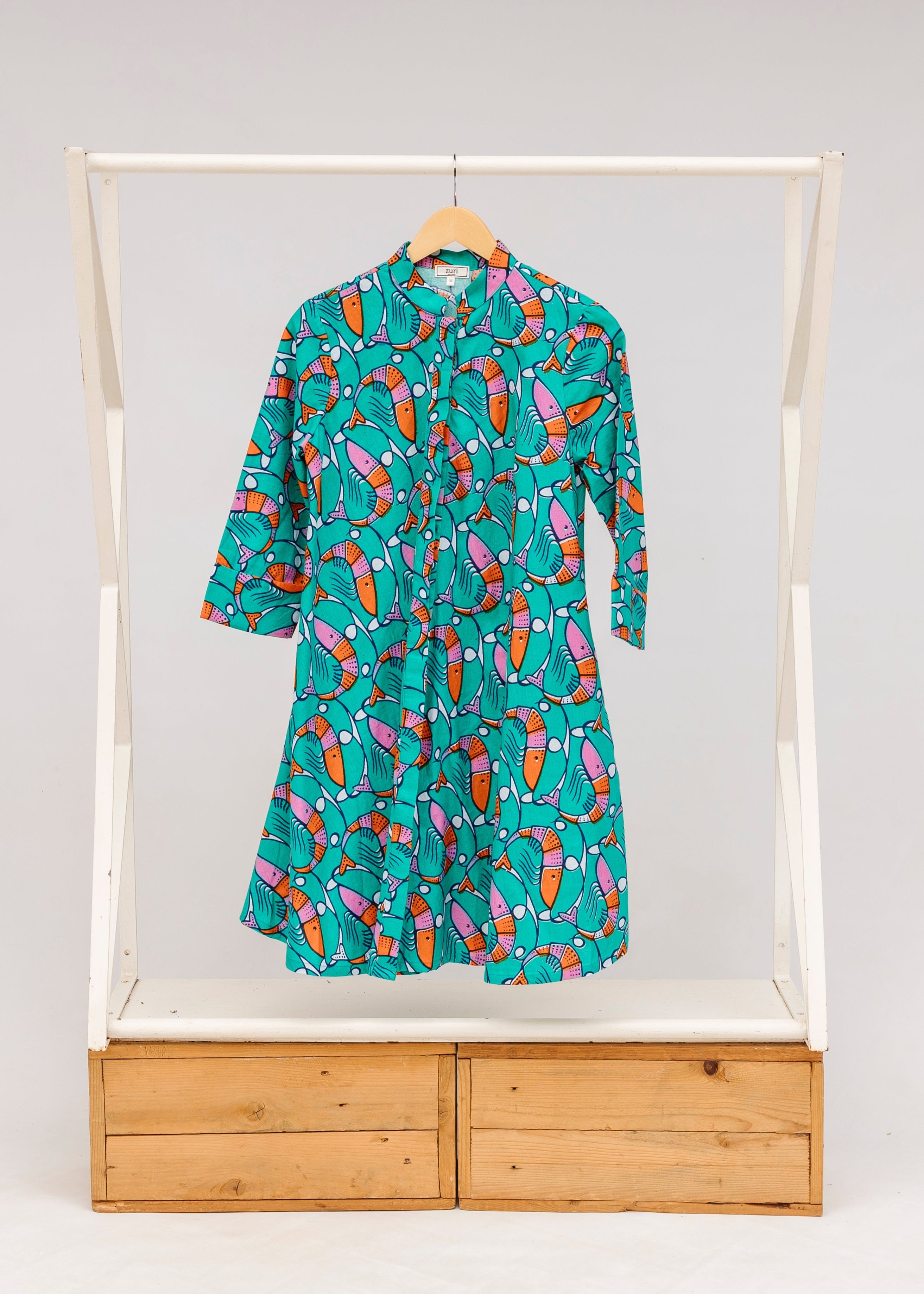 Display of teal dress with pink and orange shrimp print.