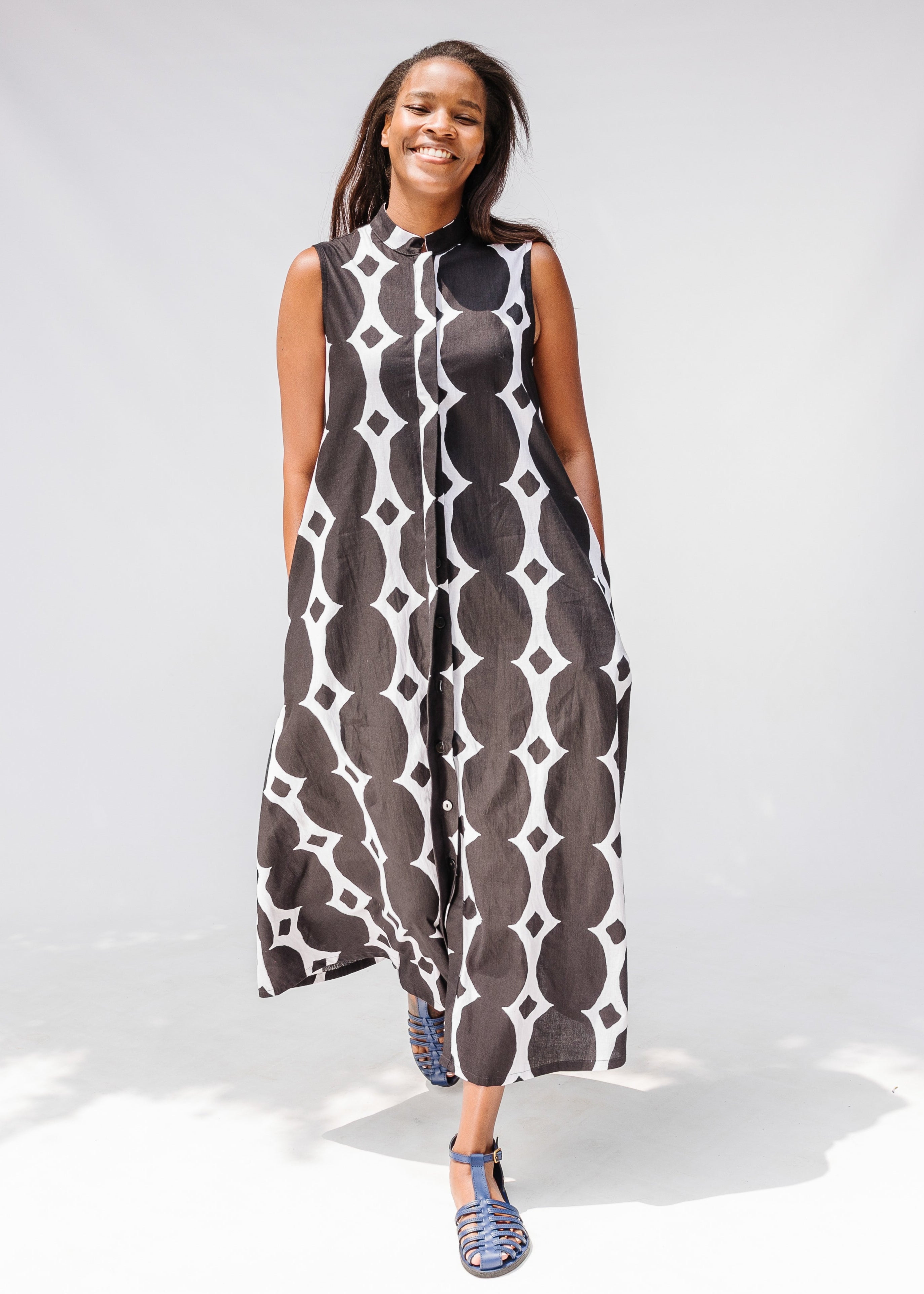 Model wearing black and white geometric print dress.