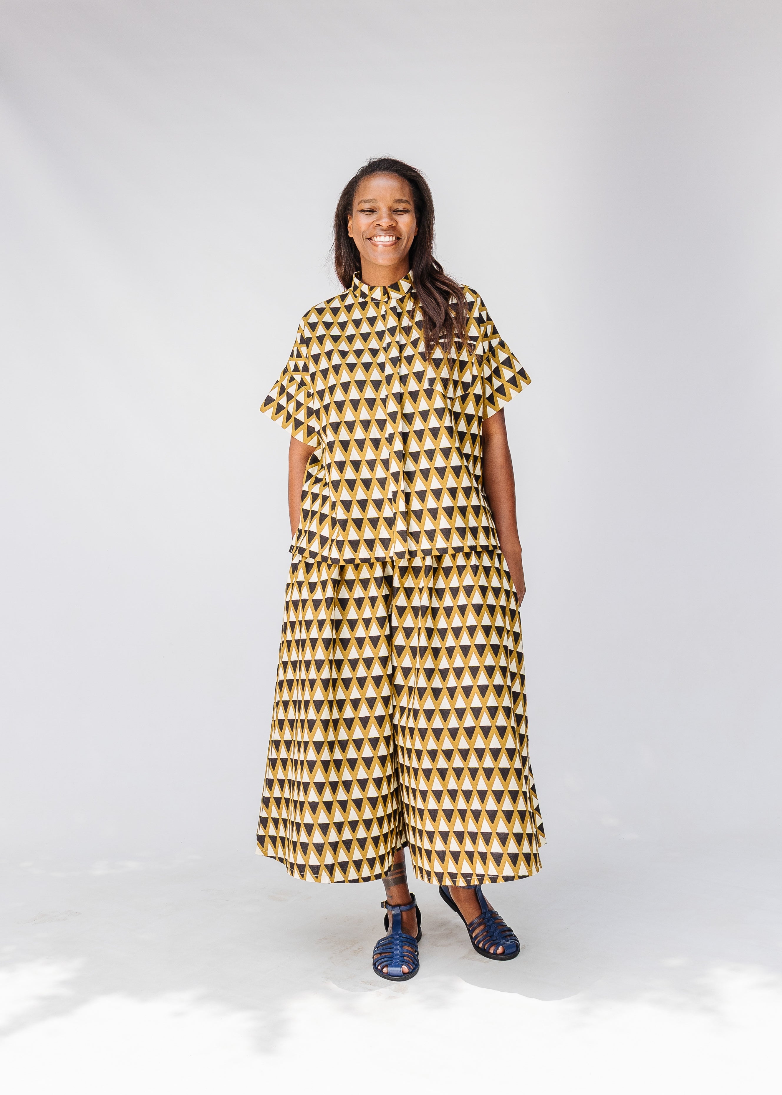 Model wearing black and beige top and matching culotte.