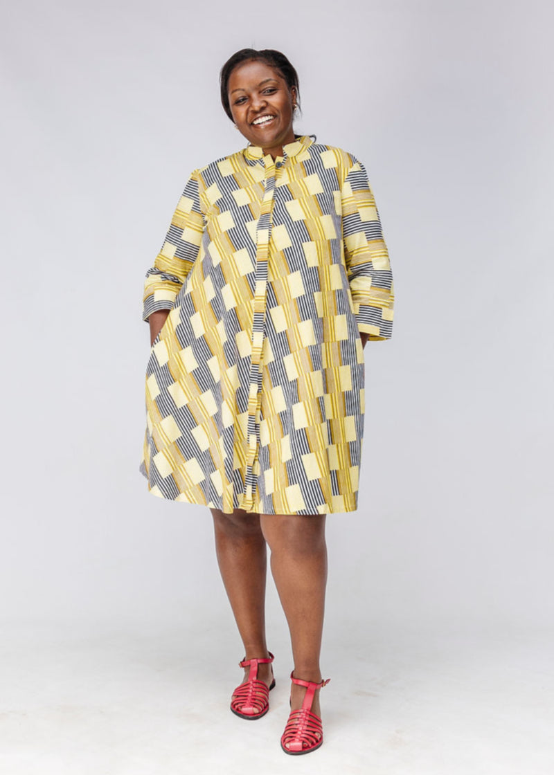 Model wearing yellow and black striped dress.