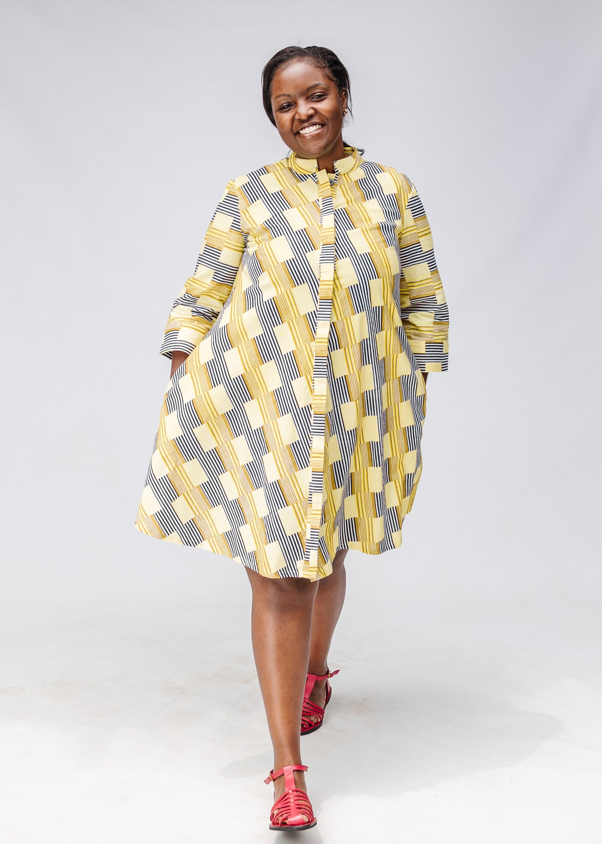 Model wearing yellow and black striped dress.