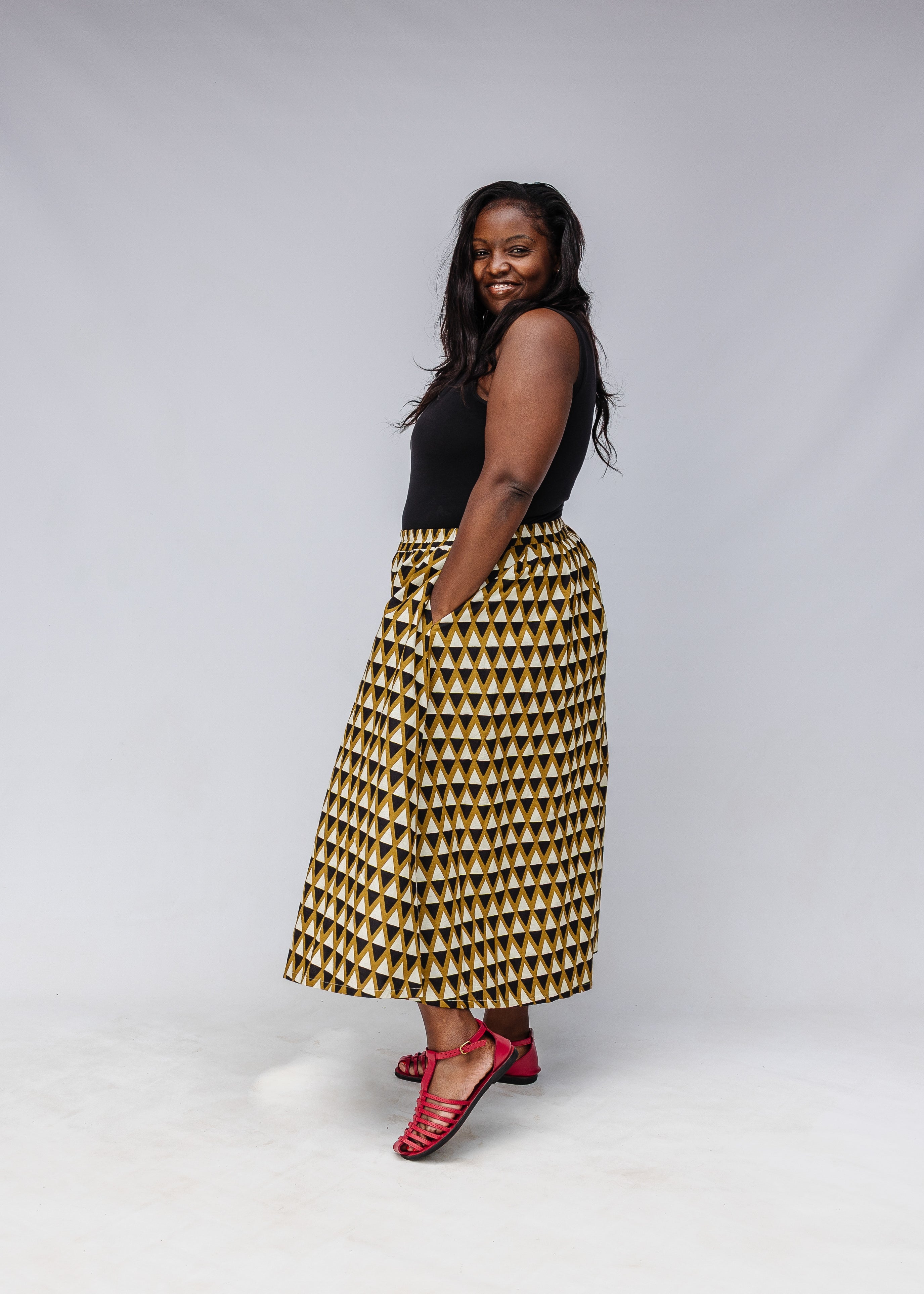 Model wearing black top with black and beige culotte