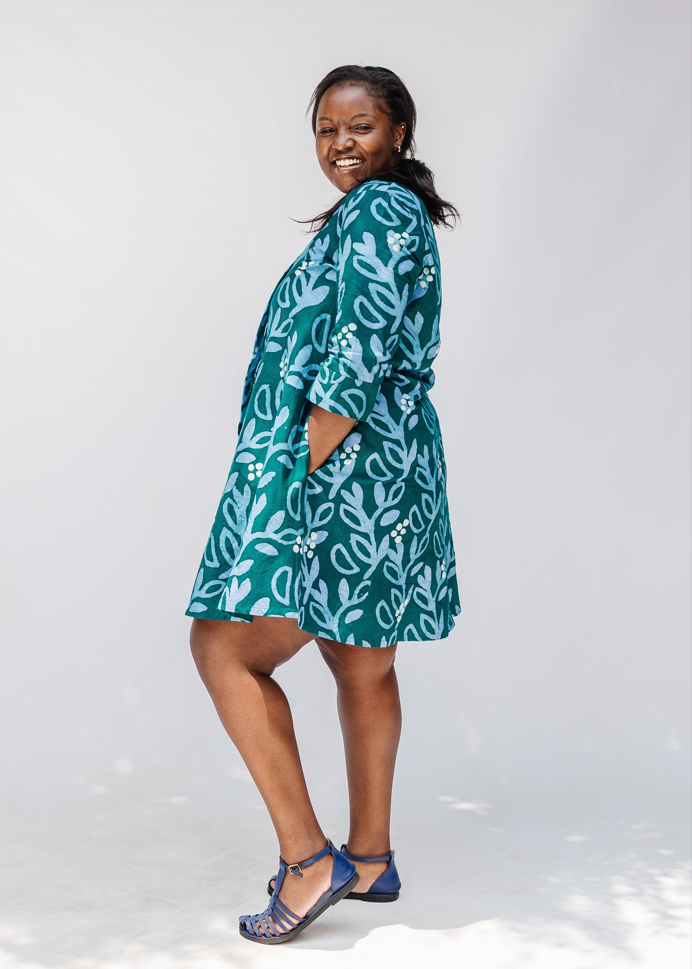 Model wearing green and blue floral batik dress. 