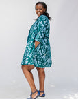 Model wearing green and blue floral batik dress. 