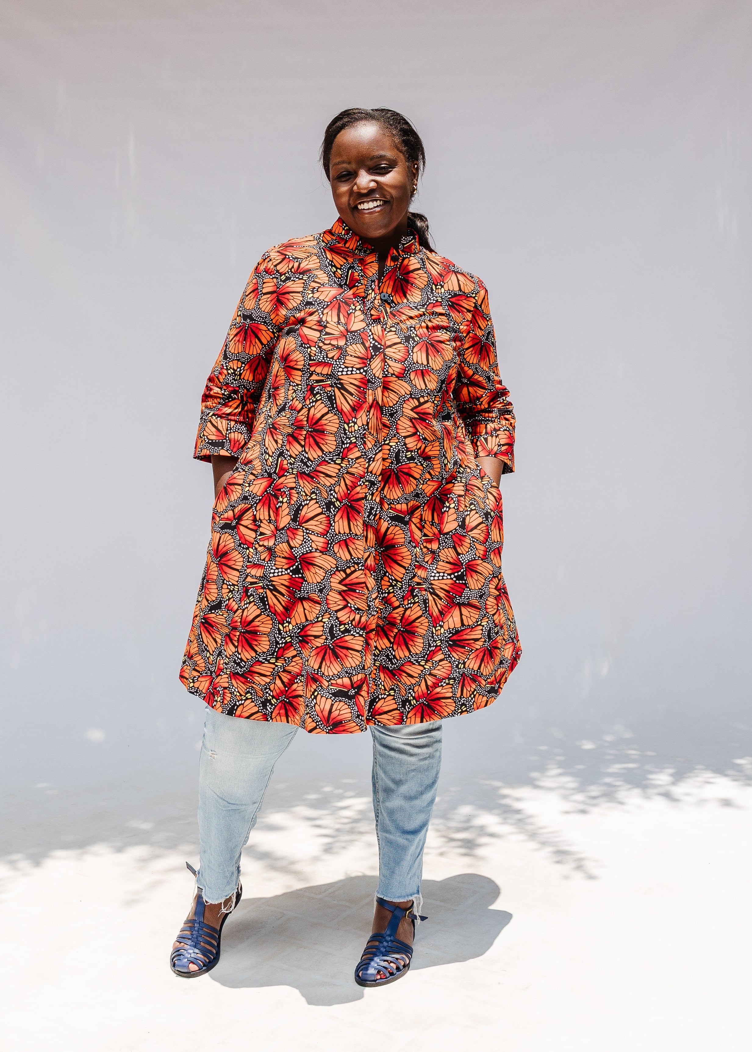 Model wearing butterfly print dress.