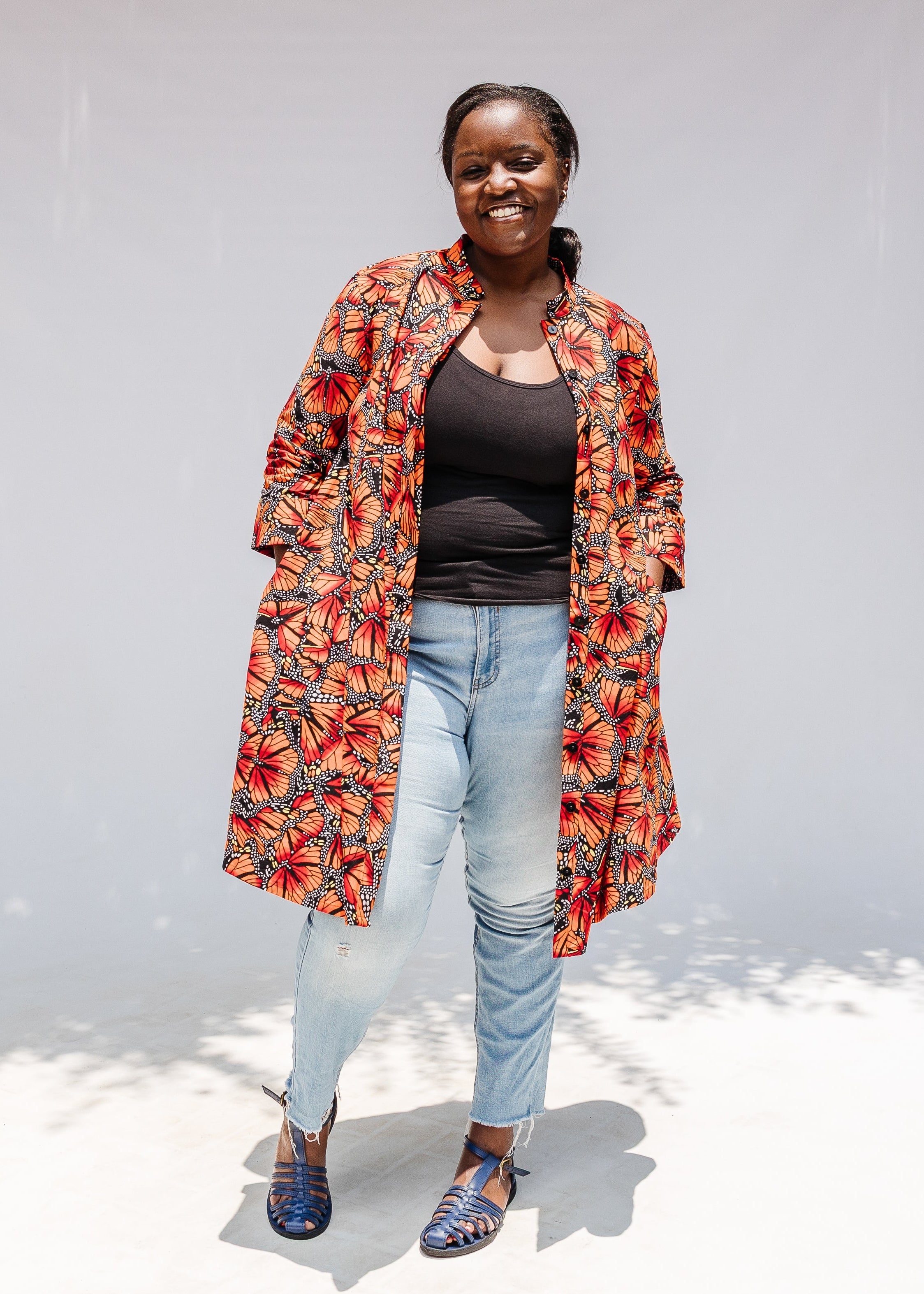 Model wearing butterfly print dress.