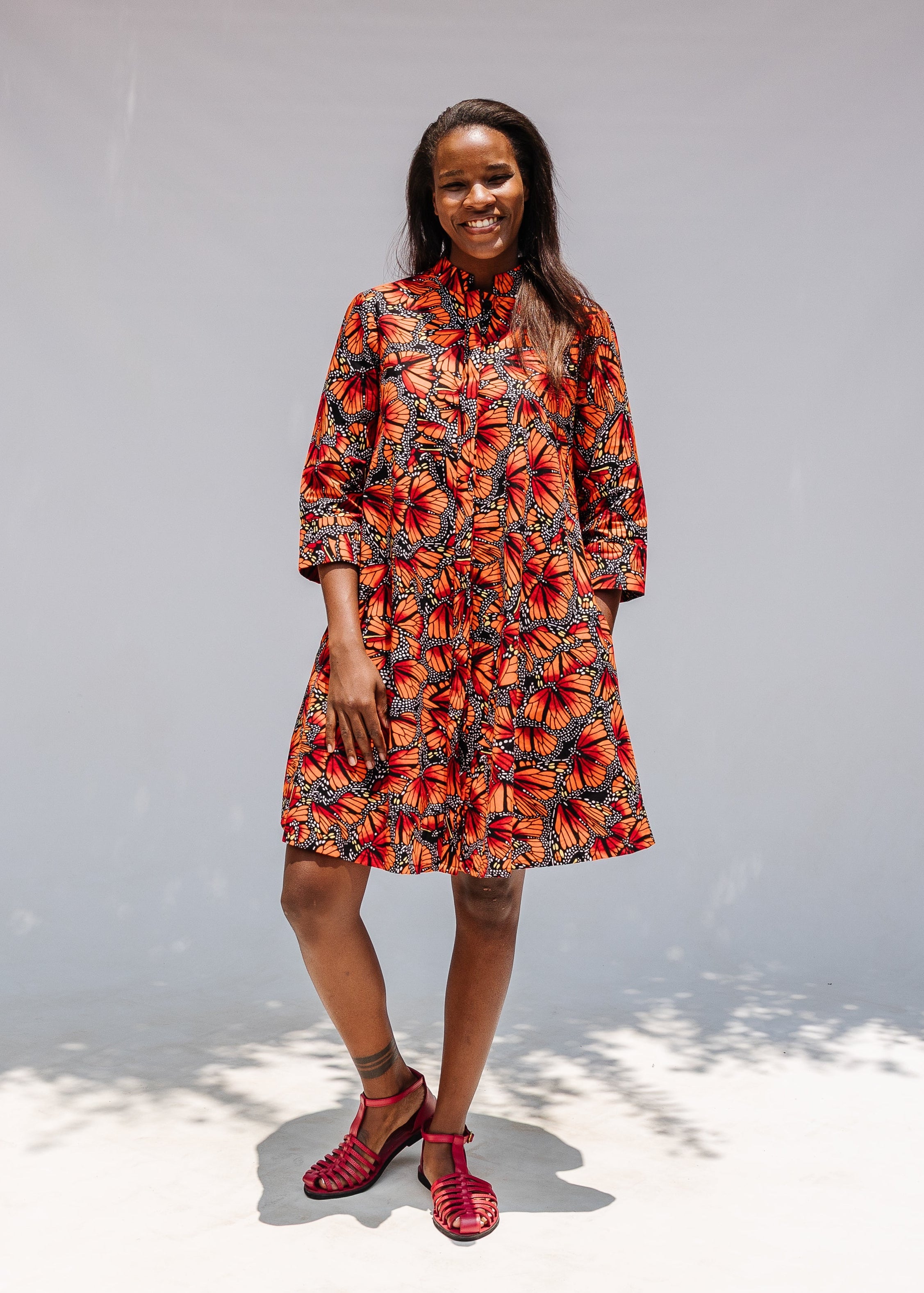 Model wearing butterfly print dress.