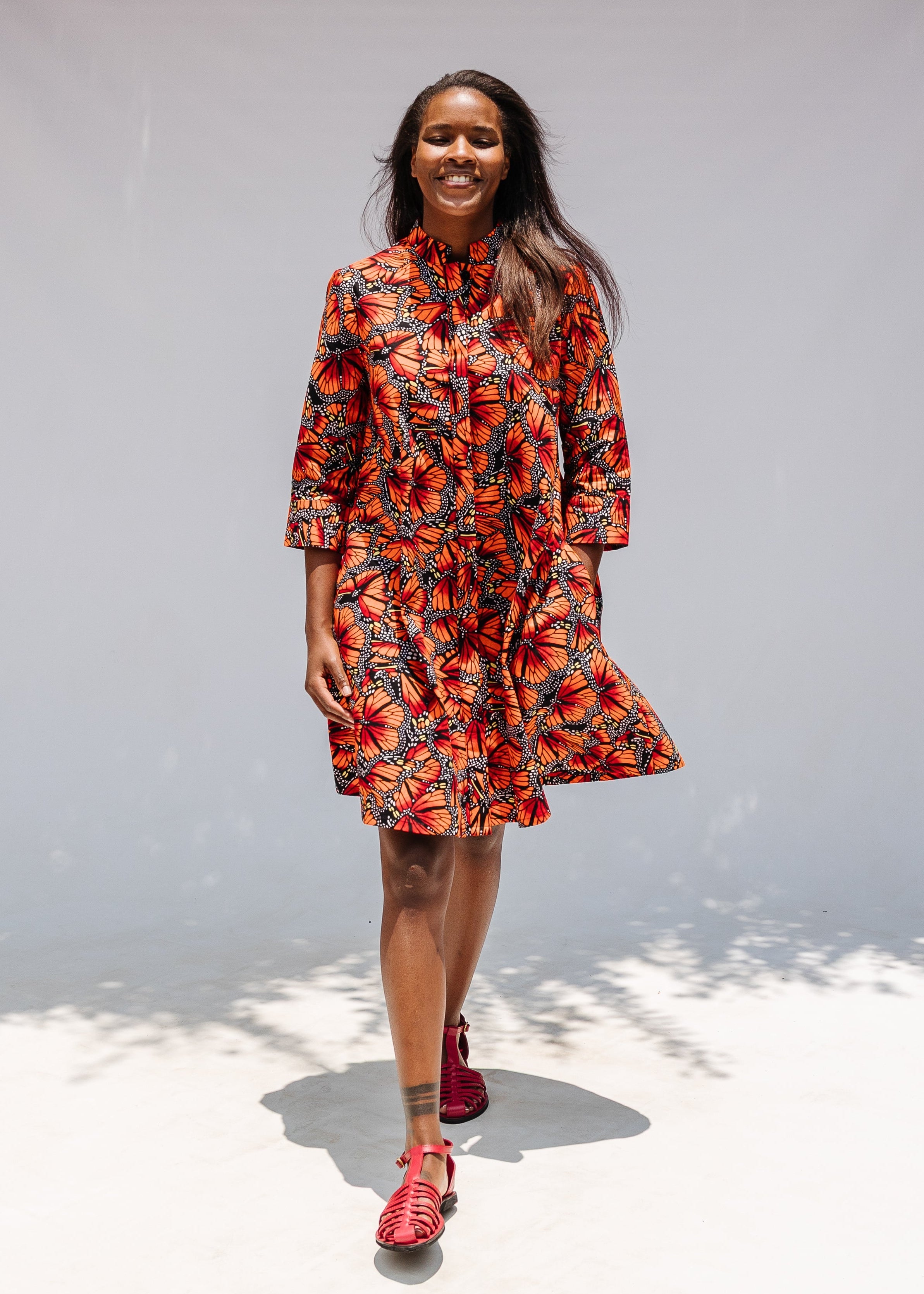 Model wearing butterfly print dress.
