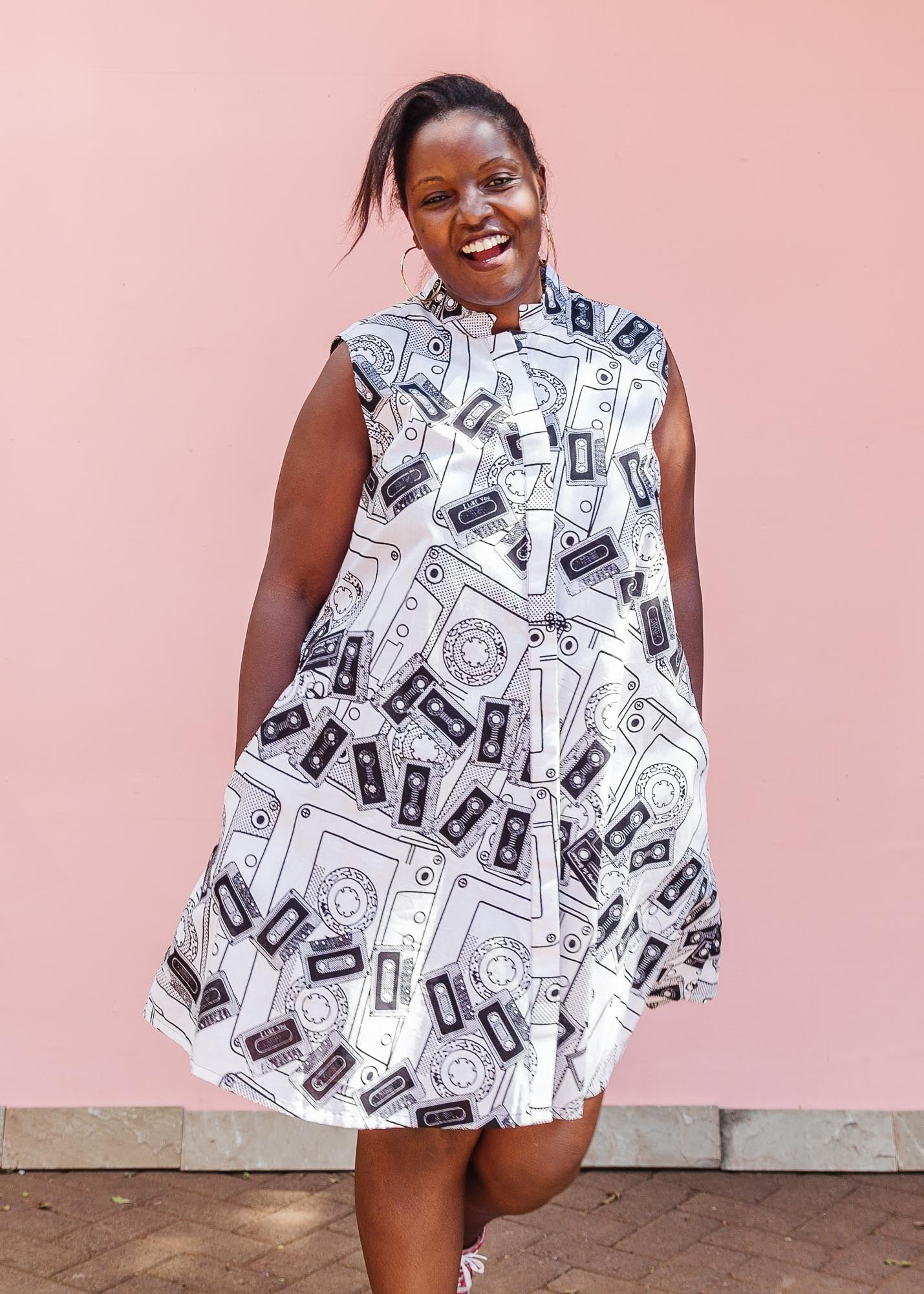 The model is wearing black and white pictorial print with tapes 