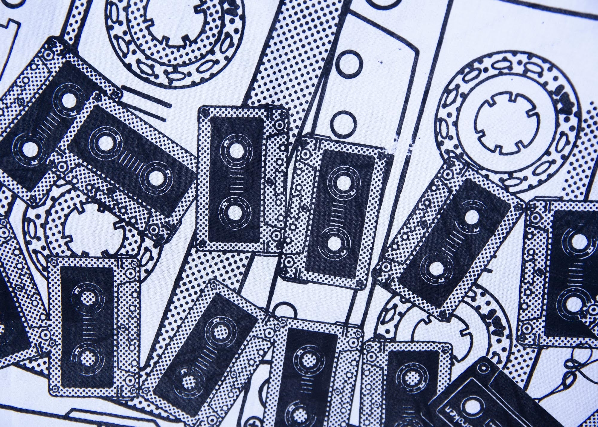 Close up display of black and white pictorial print with tapes 