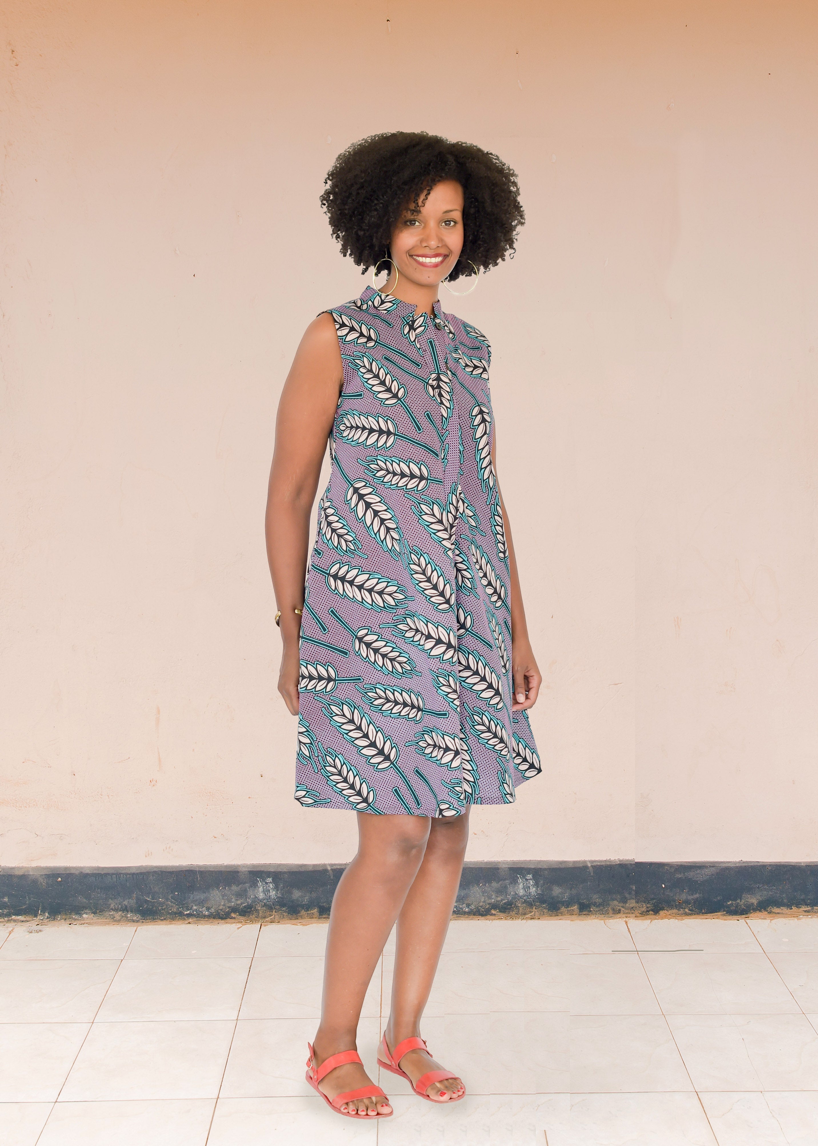 Model wearing purple sleeveless dress with wheat print.