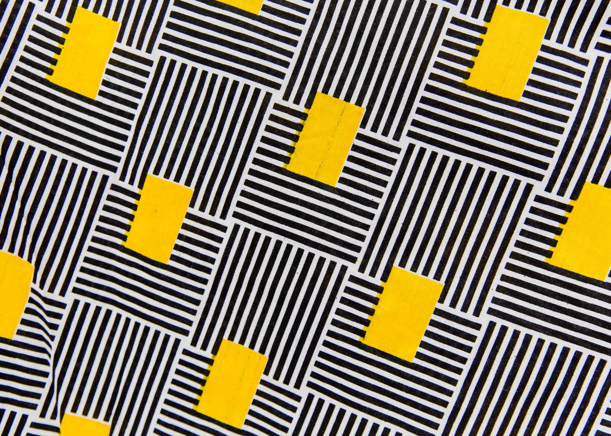 Display of black and white striped dress with yellow block print.